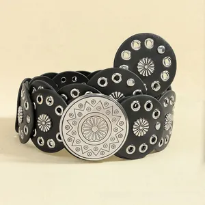 Detail of Bohemian black leather waist belt featuring sun flower rivets and silver metal buckle