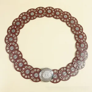 Detail of bohemian waist belt featuring brown leather discs with silver sunflower rivets