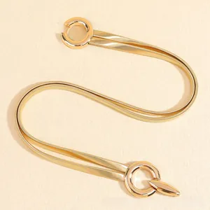 Detailed shot of gold-tone double-layered elastic spring waist chain with round buckle