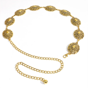 Close-up of golden boho waist chain featuring engraved floral metal discs and lobster clasp