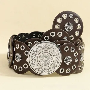 Detail of vintage bohemian belt featuring round leather discs and silver floral buckle