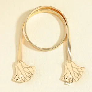 Detail of golden elastic snake chain belt with leaf-shaped metal buckle and hook