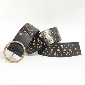Detail of a vintage punk belt with round eyelets and bronze studs on matte black leather