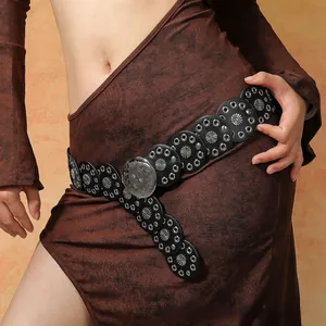 Detail view of retro Bohemian waist belt with ornate silver metal discs on black dress