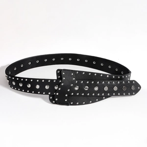 Close-up of black punk belt featuring silver metal studs and eyelets on high-quality leather