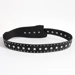Detailed macro view of black punk belt featuring silver metal studs and eyelets