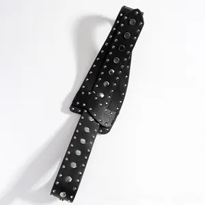 Detail view of black punk leather belt with rows of silver metal rivets on white background