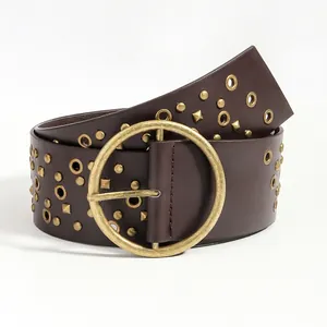 Detail of vintage wide brown leather belt with bronze rivets and large round buckle