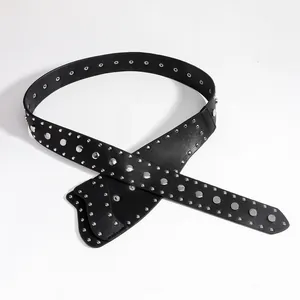 Detail view of punk style black leather belt with silver metal rivets and side holster bag