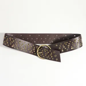 Detail of dark brown leather belt with gold round eyelets and square studs