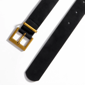 Detail of premium black leather belt featuring a vintage gold brushed metal square buckle