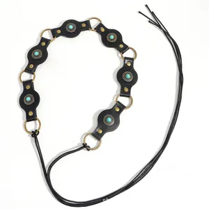 Detail of bohemian black leather concho belt with turquoise stone and metal accents