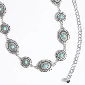 Close-up of bohemian metal waist chain with turquoise stones and engraved silver discs