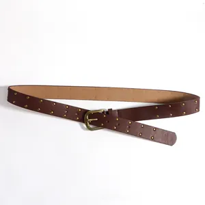 Detail view of a vintage punk dark brown PU belt with double-row round metal rivets