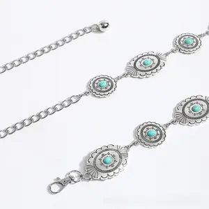 Detailed macro view of bohemian silver belt with turquoise stones and floral carvings