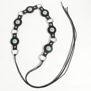 Detail of bohemian black leather belt with turquoise stones and silver flower studs