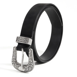 Close-up of vintage black belt with ornate Western scroll engraved silver metal buckle
