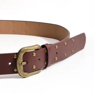 Detailed close-up of dark brown PU leather belt with vintage gold studs and buckle