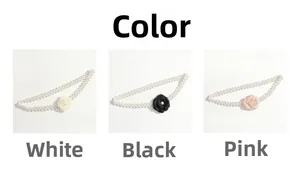 Detail view of pearl waist chains with fabric camellia flowers in white black and pink