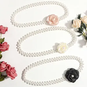 Elegant double-row pearl waist belt with camellia floral buckle in pink, white, and black
