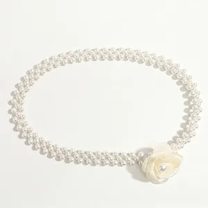 Elegant double-row pearl belt with a white camellia flower decoration on white background