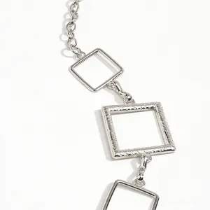 Detail der silbernen Metall-Taillenkette mit gehämmerter Struktur und polierten Quadraten