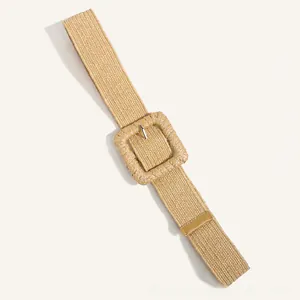Detailed view of beige straw woven belt featuring a matching square buckle and boho texture