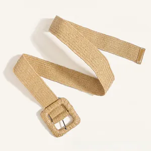Close-up of khaki woven straw waist belt with a large square buckle for summer dresses