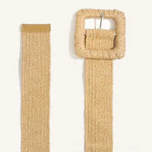 Detail view of woven straw belt with square buckle and leather-wrapped tip for durability