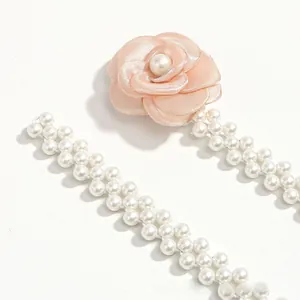Close-up of elegant camellia flower belt with white faux pearls for dresses
