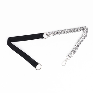 Detail of black elastic belt featuring silver punk metal chain and lobster clasp