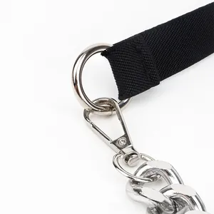 Detail of black waist belt with silver metal ring and lobster clasp on white background