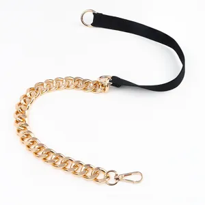 Detail of a thin PU leather belt with gold metal chain and lobster clasp for dresses