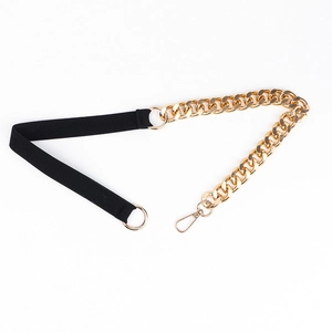 Detail of black elastic belt strap with large golden metal chain link and lobster clasp