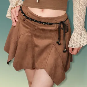 Detail of woven black belt with glossy beads on a brown suede skirt with irregular hem