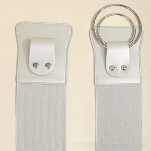 Close-up of silver metal double ring buckle on fashionable wide elastic waist belt for women