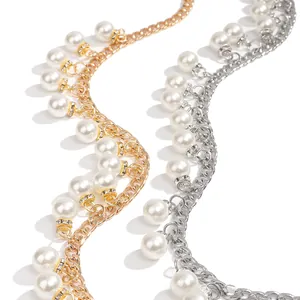 Detail of elegant gold and silver chain belts with faux pearls and sparkling rhinestones