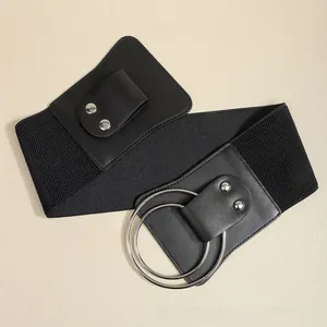 Detail view of black elastic wide waist belt with double silver rings and rivets