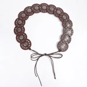 Detail view of Bohemian leather belt with round discs and carved metal studs