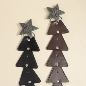 Detail of bohemian star buckles with engraved metal and layered leather on vintage belts