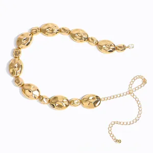 Detail der verstellbaren goldenen Taillenkette mit polierten unregelmäßigen Metallbohnen