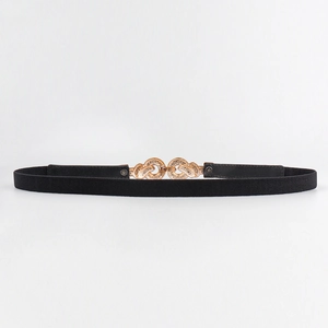 Detail showing the interlocking golden double circle buckle on a black elastic belt