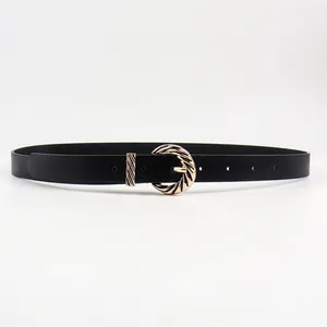 Close-up of black skinny belt featuring a twisted golden metal buckle and adjustment holes