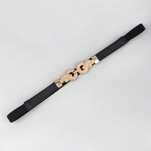 Close-up of women's black elastic waist belt with textured gold double ring buckle detail