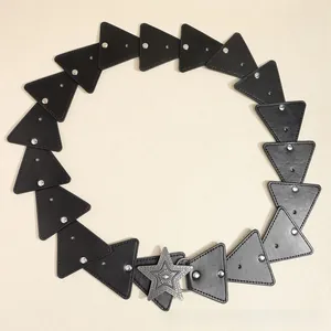 Detail of bohemian black belt with silver star buckle and geometric rivet patchwork