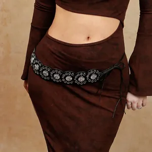 Detail view of Bohemian waist chain with black round discs and silver metal engraving