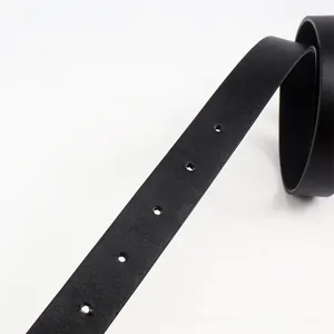 Detail view of black leather belt with fine lychee texture and five adjustment holes