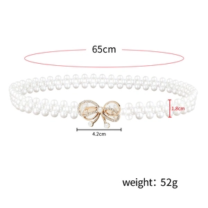 Women's elastic pearl belt with gold rhinestone bow buckle on white background