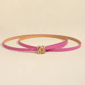 Detail of rose pink slim belt showing 3D golden rose buckle and adjustable eyelets