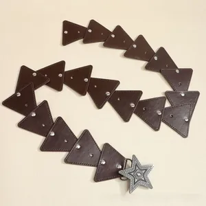 Detail of bohemian leather belt with star buckle and decorative silver metal studs